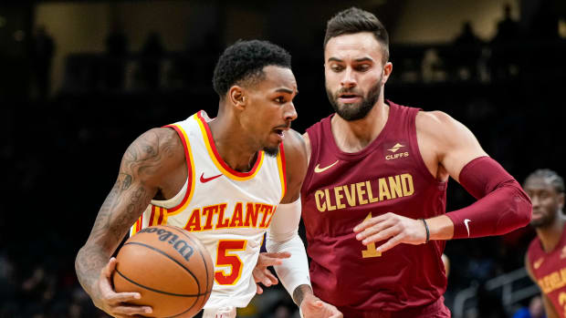 Oct 10, 2023; Atlanta, Georgia, USA; Atlanta Hawks guard Dejounte Murray (5) dribbles against Cleveland Cavaliers guard Max Strus (1) during the first half at State Farm Arena.